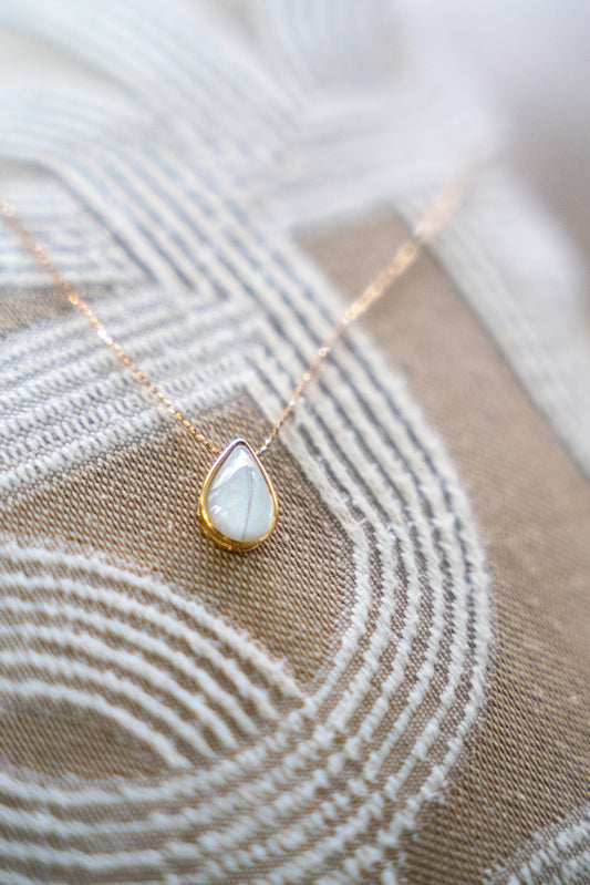 Solid gold breastmilk necklace with a teardrop keepsake stone, the Dewdrop