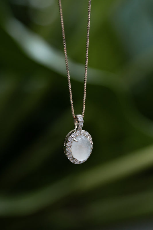 Solid gold breastmilk necklace with a diamond halo pendant, matching the Celestine Halo Ring