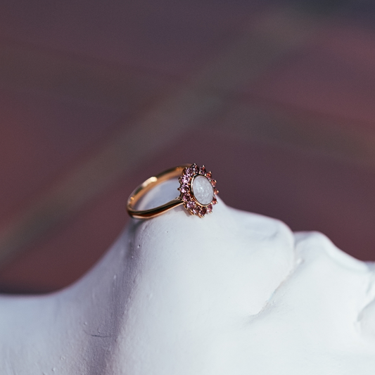 Solid gold breastmilk ring with a warm pink tourmaline halo, the Roseglow