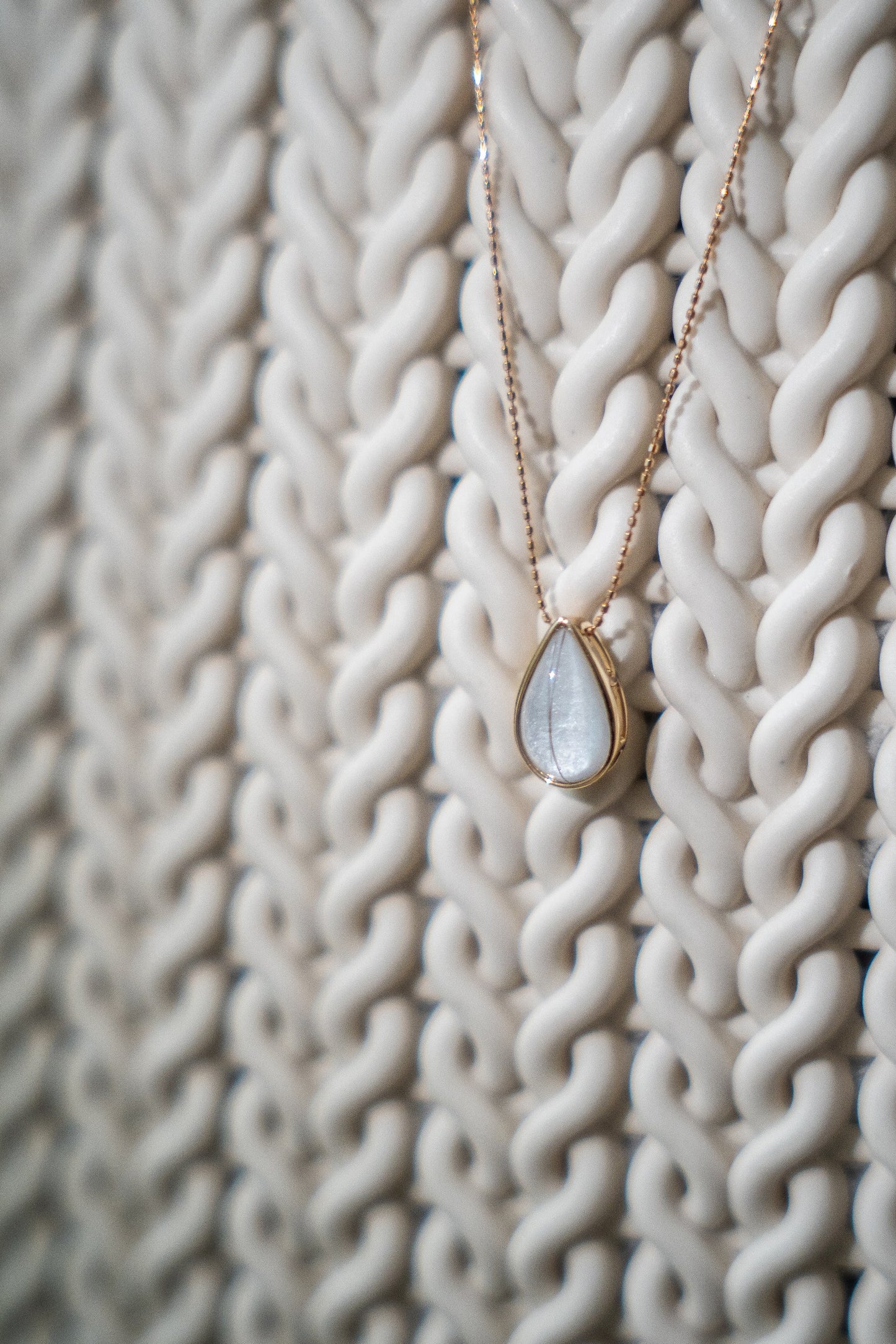 Teardrop breastmilk stone pendant on a fine gold chain, the Dewdrop Necklace