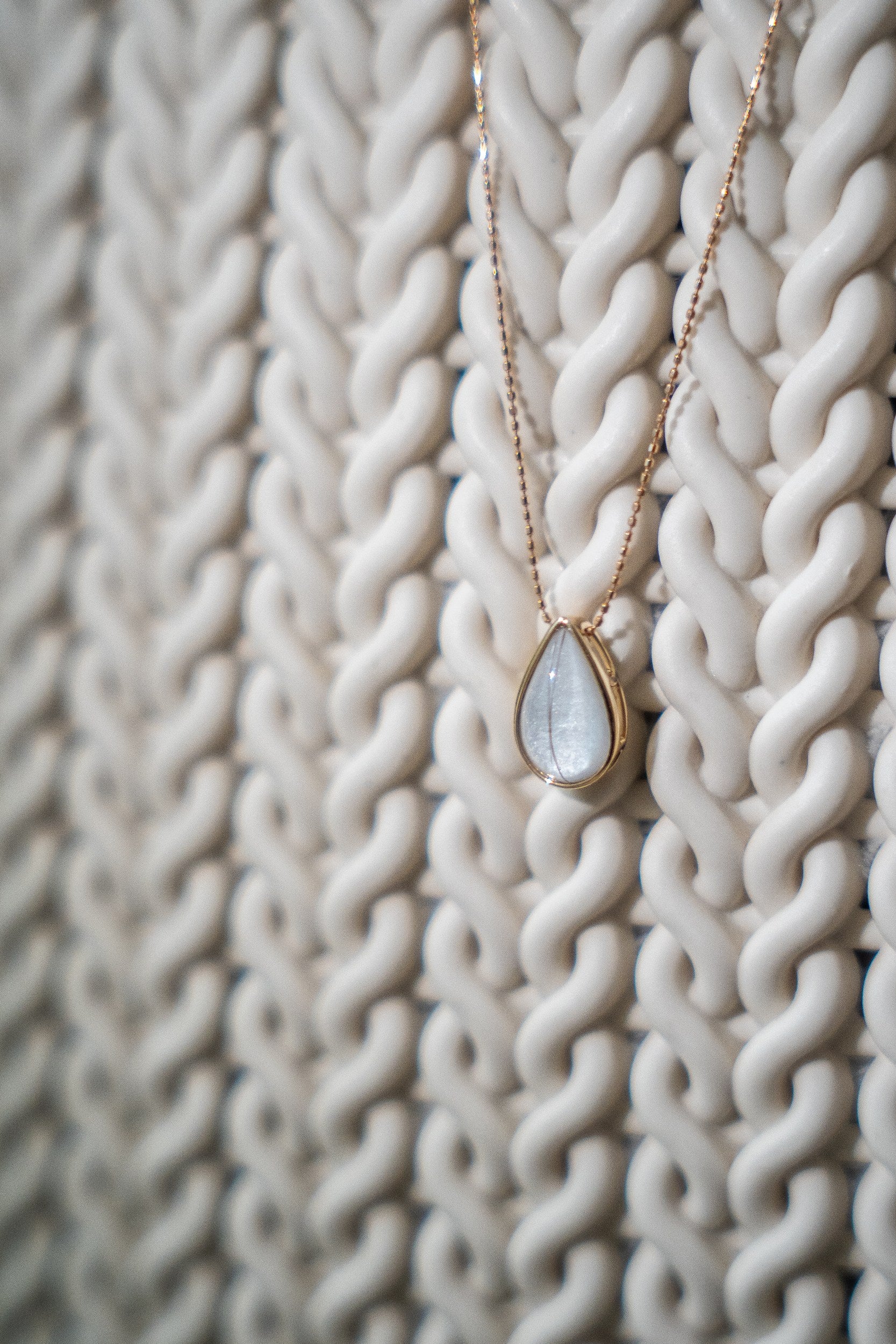 Teardrop breastmilk stone pendant on a fine gold chain, the Dewdrop Necklace