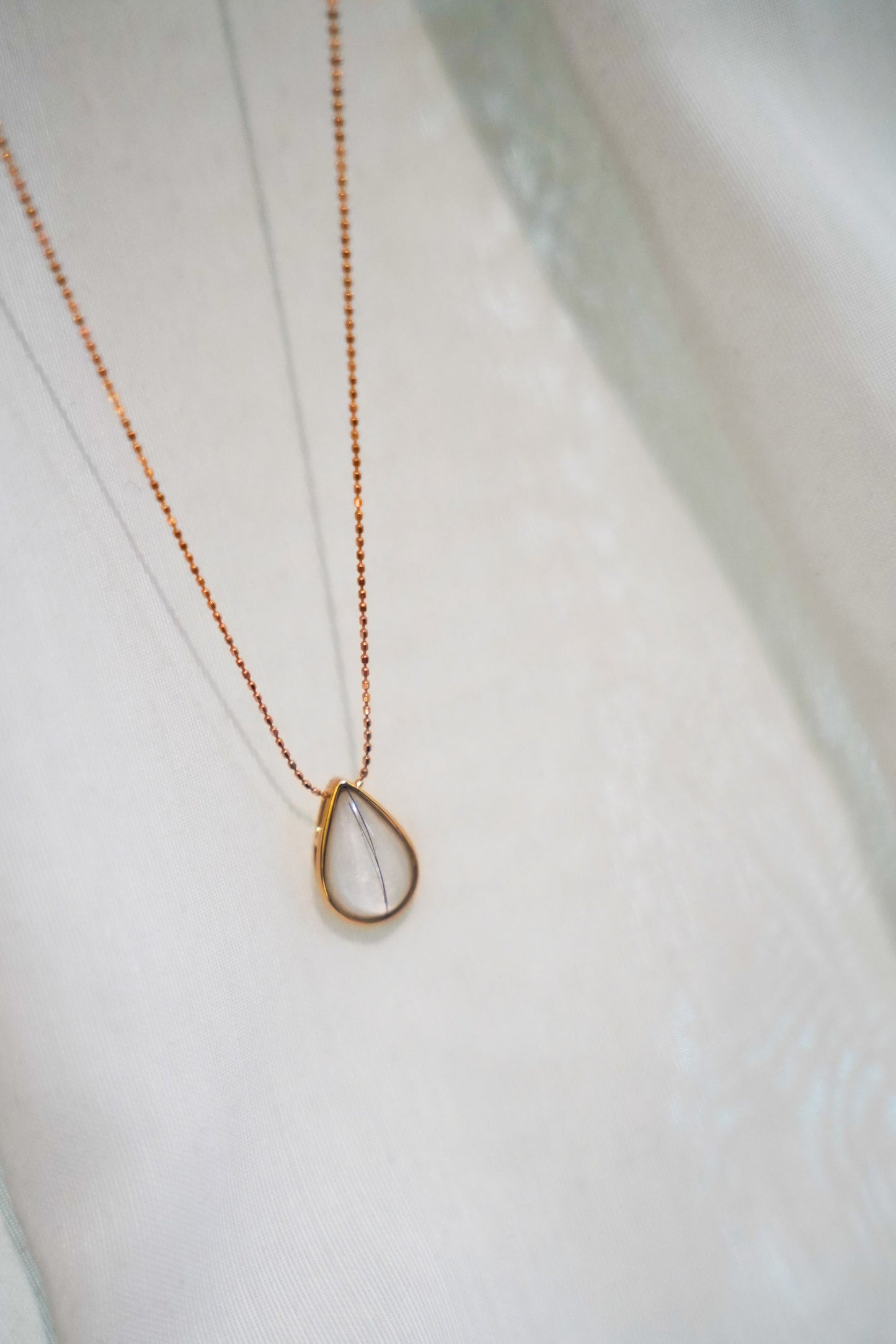 The Dewdrop breastmilk necklace in solid gold, a delicate keepsake