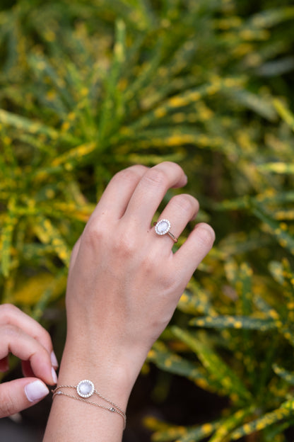 The Illumine Halo breastmilk bracelet, keepsake stone framed by diamonds on a gold chain