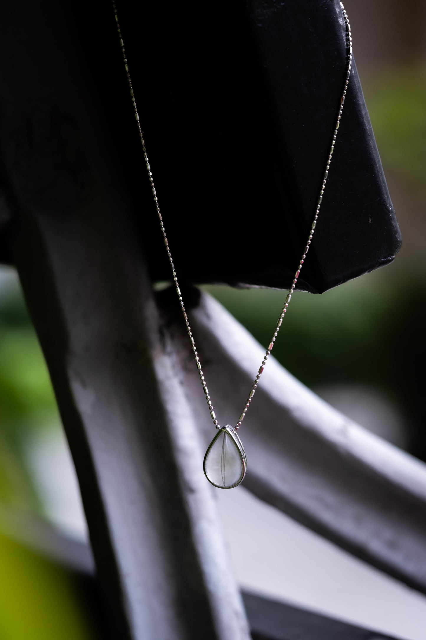 Breastmilk teardrop pendant in solid gold on the Dewdrop Necklace