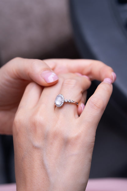 Eternity Ring, a breastmilk stone framed by a diamond halo with diamonds along the band