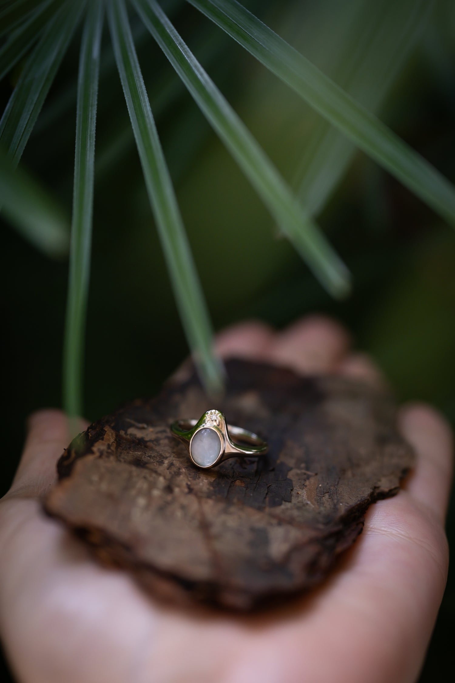 The North Star Ring with a breastmilk stone and diamond in a star-inspired setting, solid gold