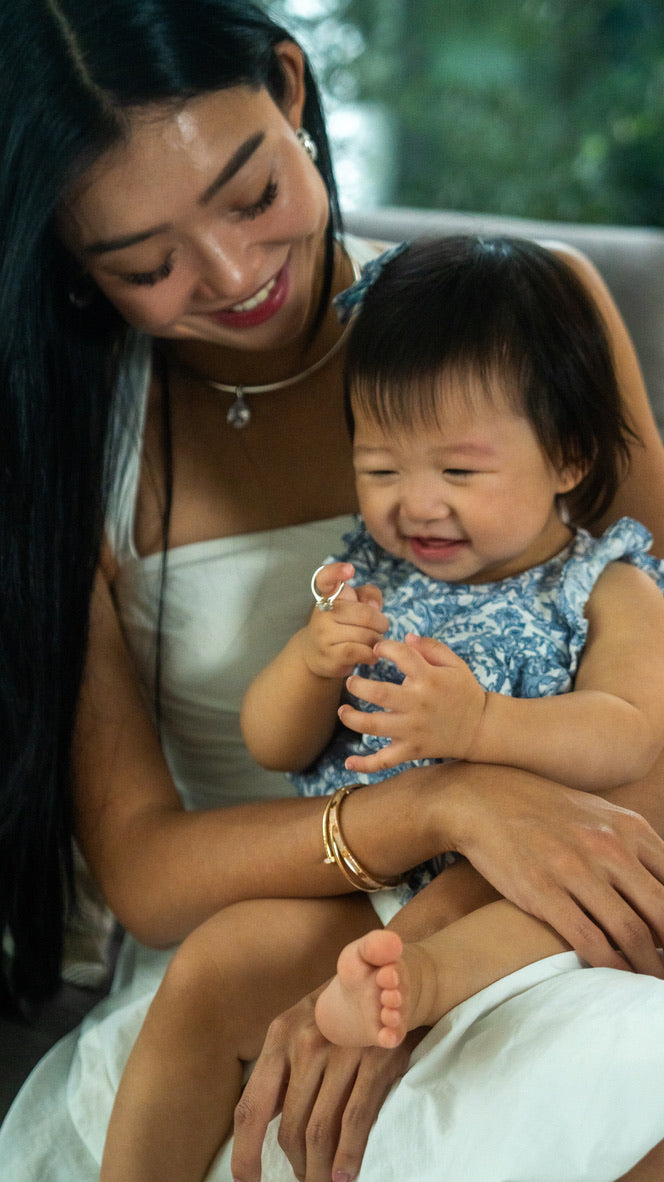 Oval breastmilk stone in a diamond halo, the Celestine Halo Ring in solid gold